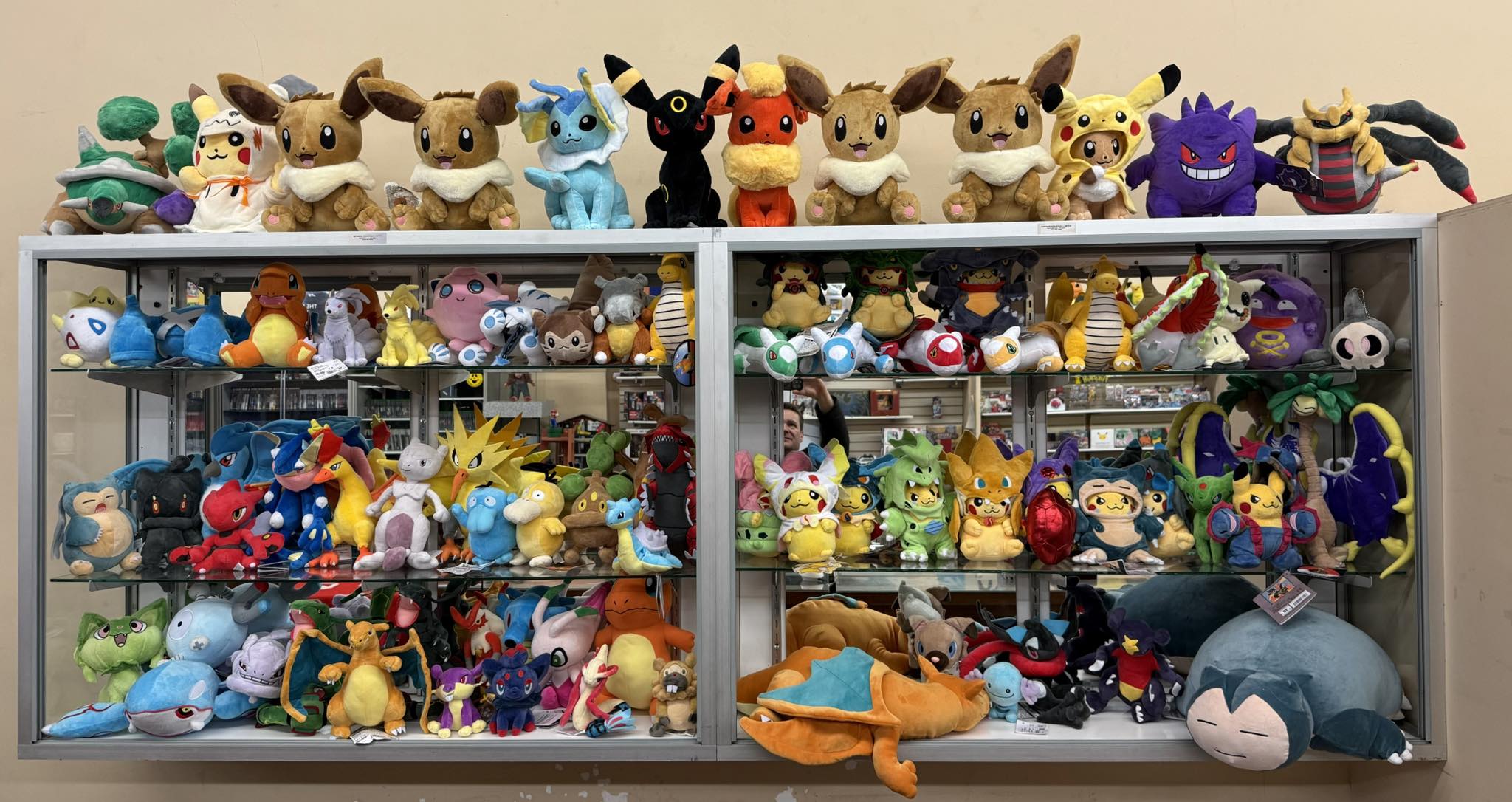 Large display of Pokemon plush toys filling glass cabinets at Uncle Buck's Orillia